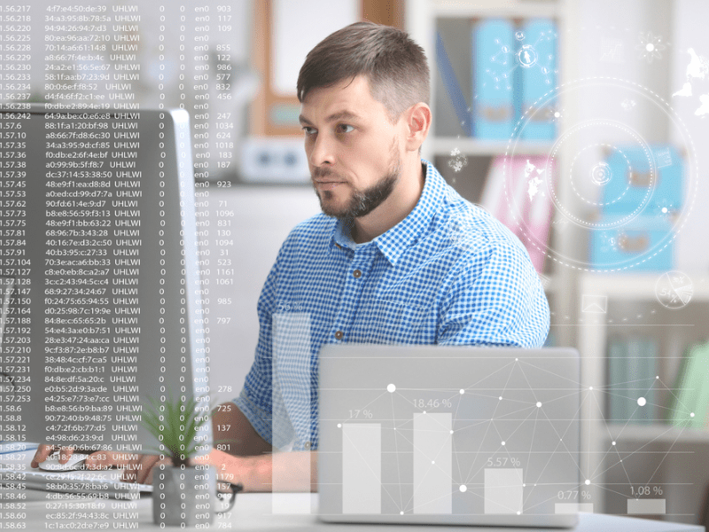 man looking at computer with log information