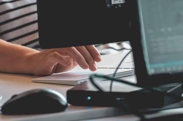hands working on a computer keyboard