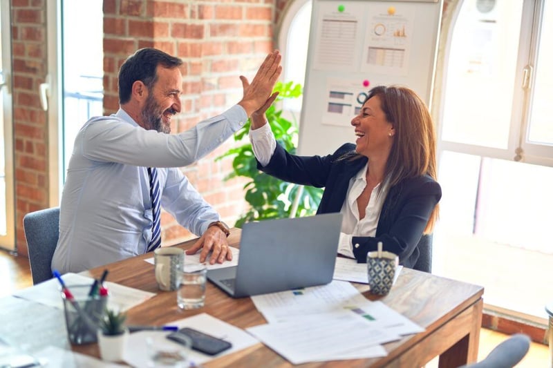 people in office giving high 5