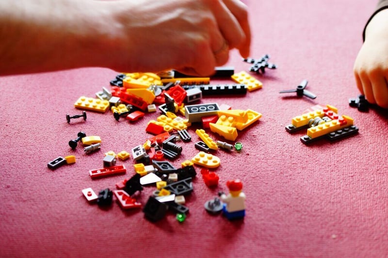 hand playing with lego building blocks