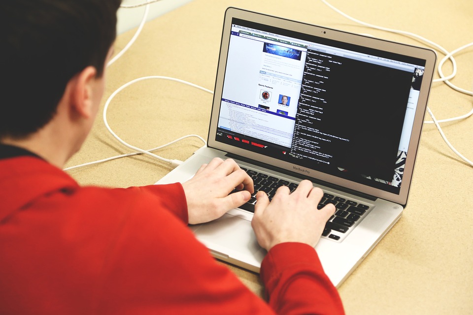 man coding on a laptop